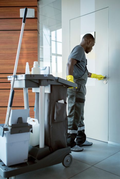 full-shot-man-cleaning-doorknob (1)